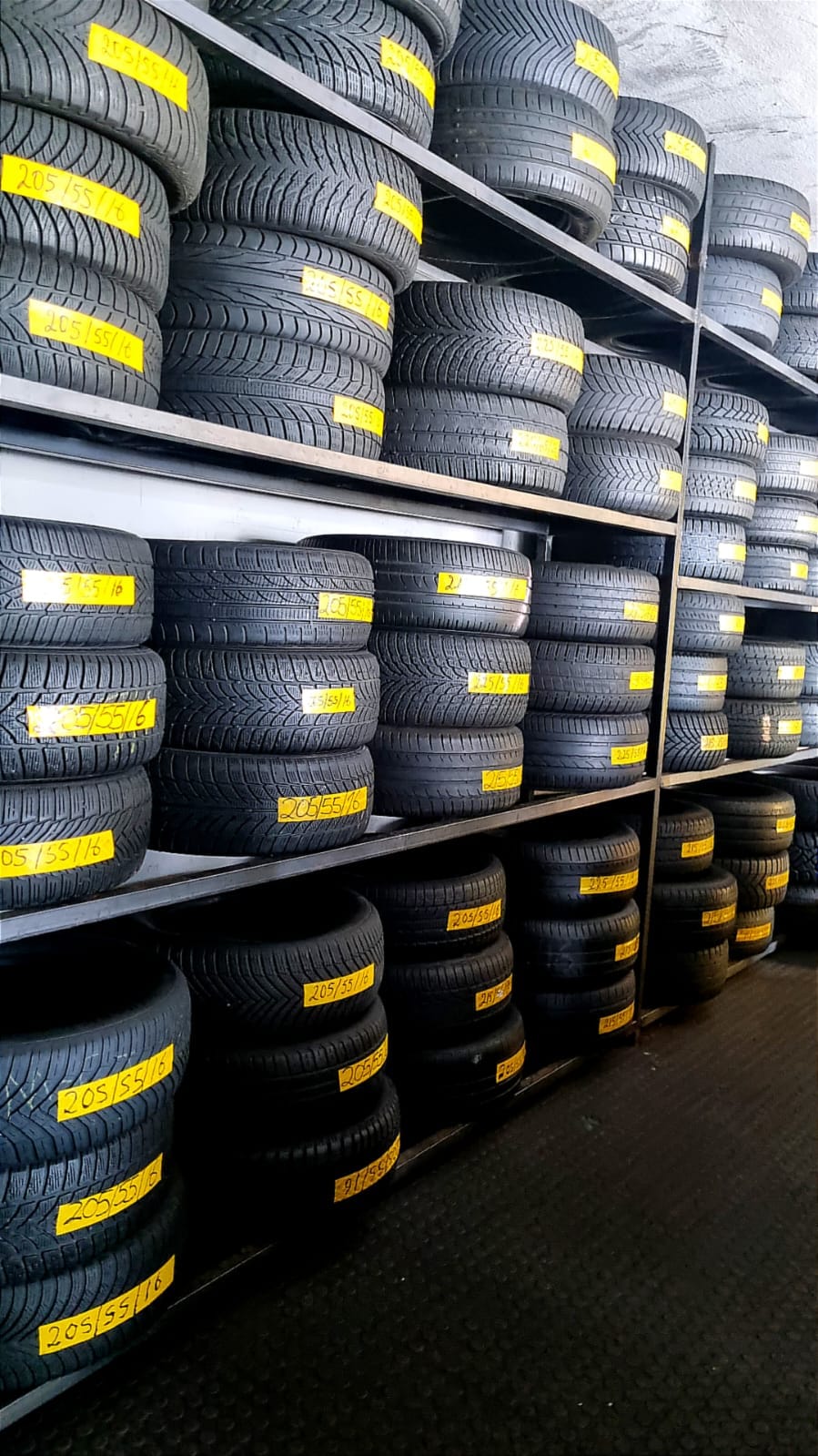 Racks of tyres stacked and labelled by size at Bong's Tyre Centre