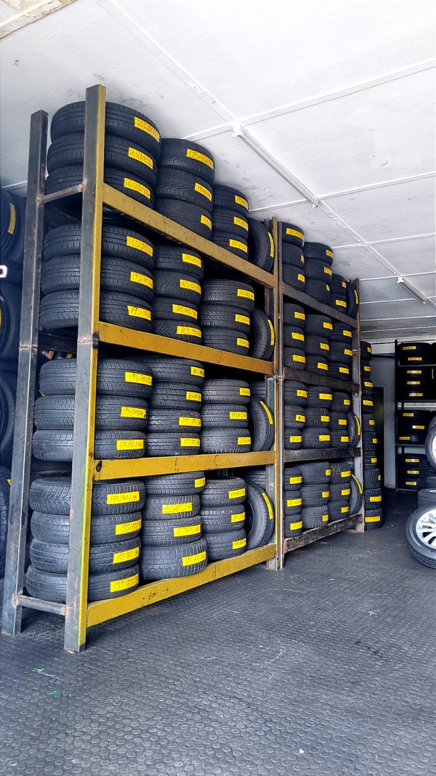 Rows of second-hand tyres racked and labelled by size at Bong's Tyre Centre
